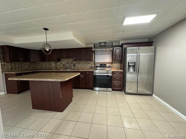 1042 Drexel St, Dearborn, MI 48128 - kitchen featuring stainless steel appliances, tasteful backsplash, a center island, and light tile patterned floors