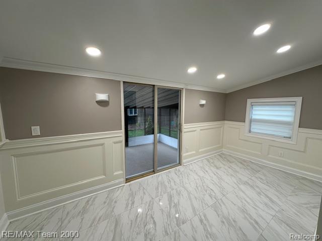 1042 Drexel St, Dearborn, MI 48128 - spare room with crown molding, a decorative wall, a wainscoted wall, and recessed lighting