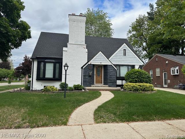 1042 Drexel St, Dearborn, MI 48128 - english style home featuring a chimney and a front yard