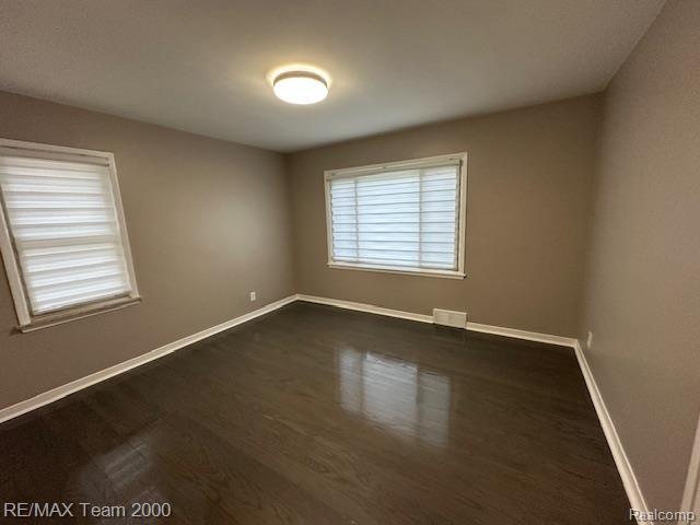 1042 Drexel St, Dearborn, MI 48128 - spare room featuring baseboards and dark wood finished floors