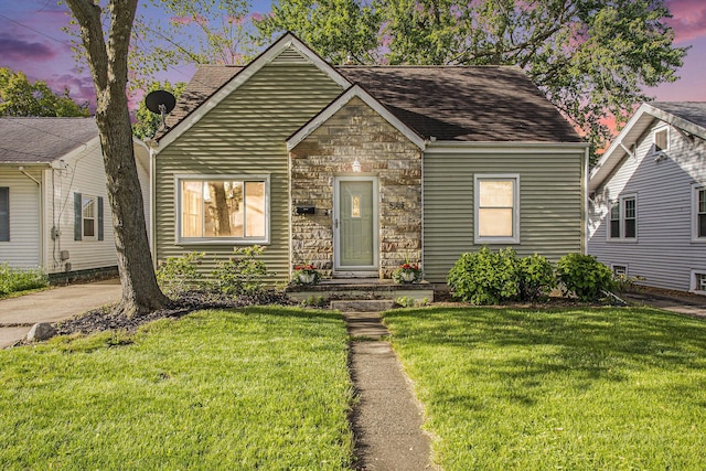 515 Fairfield Ave, Battle Creek, MI 49015 - view of front of house featuring stone siding, a yard, and a shingled roof