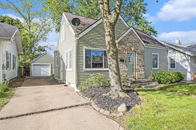 515 Fairfield Ave, Battle Creek, MI 49015 - view of front of home featuring concrete driveway, a detached garage, an outdoor structure, roof with shingles, and a front lawn
