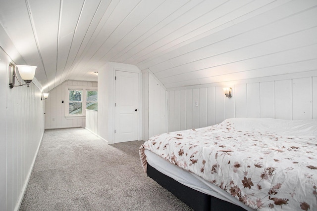 515 Fairfield Ave, Battle Creek, MI 49015 - carpeted bedroom featuring vaulted ceiling and wooden walls