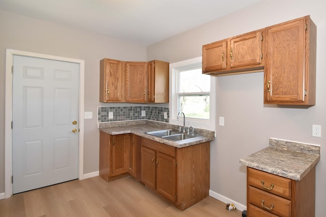 925 Princeton Ave, Kalamazoo, MI 49007 - kitchen with a sink, light wood-type flooring, and brown cabinetry
