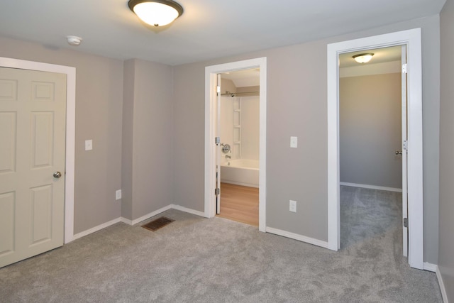 925 Princeton Ave, Kalamazoo, MI 49007 - unfurnished bedroom featuring carpet floors, a spacious closet, baseboards, and connected bathroom