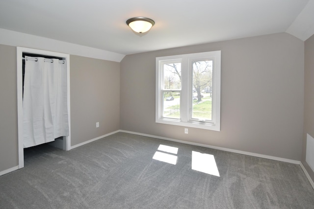 925 Princeton Ave, Kalamazoo, MI 49007 - unfurnished bedroom with vaulted ceiling, carpet, and baseboards