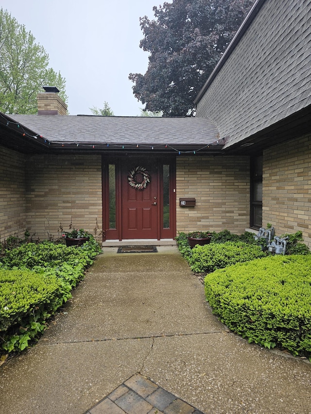 2727 S Lakeshore Dr Unit F-24, Saint Joseph, MI 49085 - property entrance with brick siding and a shingled roof
