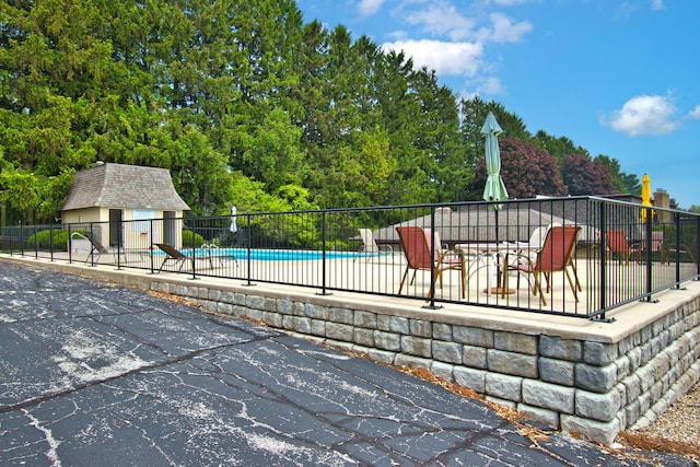 2727 S Lakeshore Dr Unit F-24, Saint Joseph, MI 49085 - wooden terrace featuring a community pool and a patio