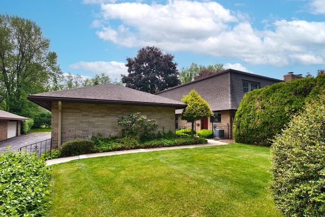 2727 S Lakeshore Dr Unit F-24, Saint Joseph, MI 49085 - view of front facade with brick siding, roof with shingles, cooling unit, and mansard roof