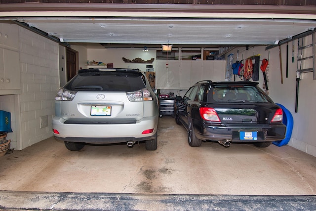 2727 S Lakeshore Dr Unit F-24, Saint Joseph, MI 49085 - garage with a garage door opener and concrete block wall