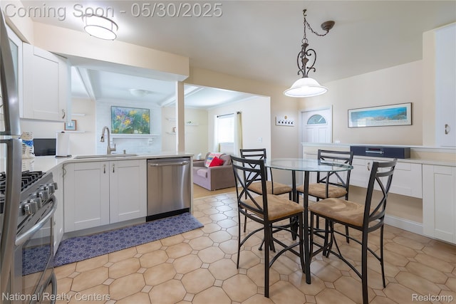 33532 Regal, Fraser, MI 48026 - kitchen with appliances with stainless steel finishes, a sink, white cabinets, light countertops, and beam ceiling