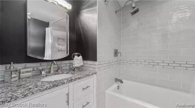 29374 W Glen Oaks Blvd, Farmington Hills, MI 48334 - bathroom with vanity, tub / shower combination, and decorative backsplash