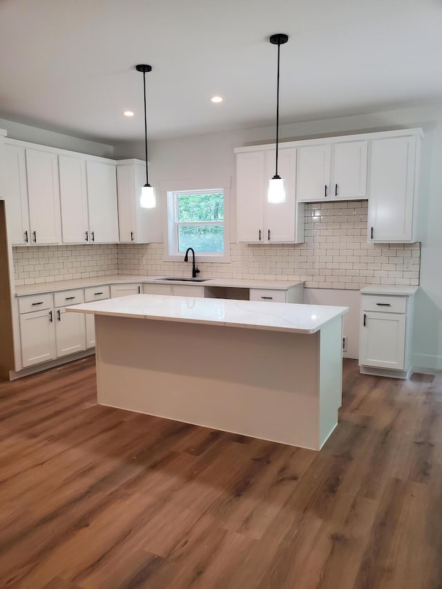 3995 112th Ave, Allegan, MI 49010 - kitchen featuring white cabinets, backsplash, hanging light fixtures, and recessed lighting