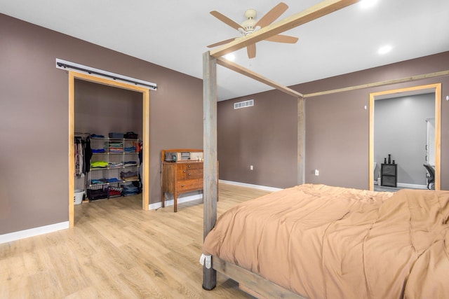 17495 Bison Trl, White Pigeon, MI 49099 - bedroom featuring a walk in closet, light wood finished floors, a closet, baseboards, and ceiling fan