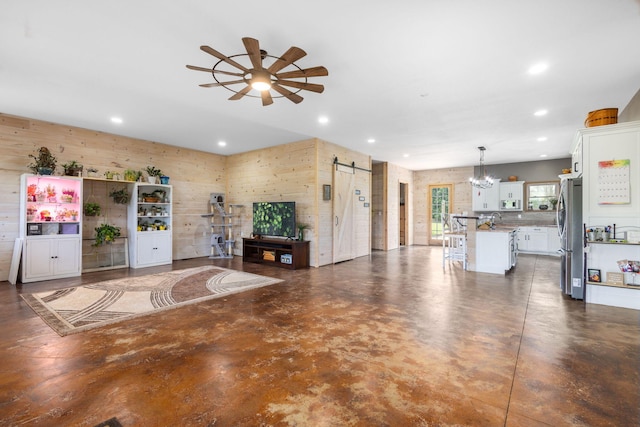 17495 Bison Trl, White Pigeon, MI 49099 - living room featuring a barn door, finished concrete flooring, ceiling fan, recessed lighting, and a chandelier