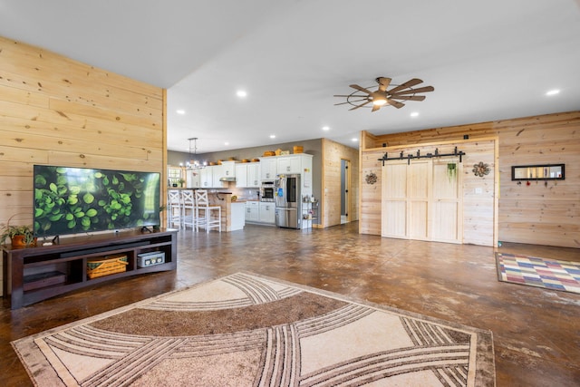 17495 Bison Trl, White Pigeon, MI 49099 - living room featuring wooden walls, a barn door, recessed lighting, finished concrete flooring, and a chandelier