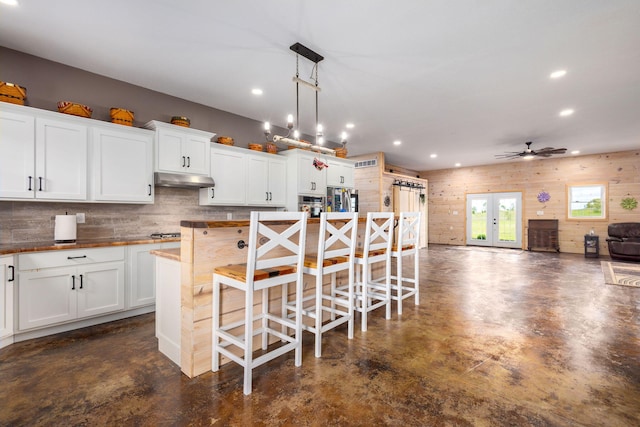 17495 Bison Trl, White Pigeon, MI 49099 - kitchen with finished concrete flooring, appliances with stainless steel finishes, recessed lighting, white cabinets, and tasteful backsplash