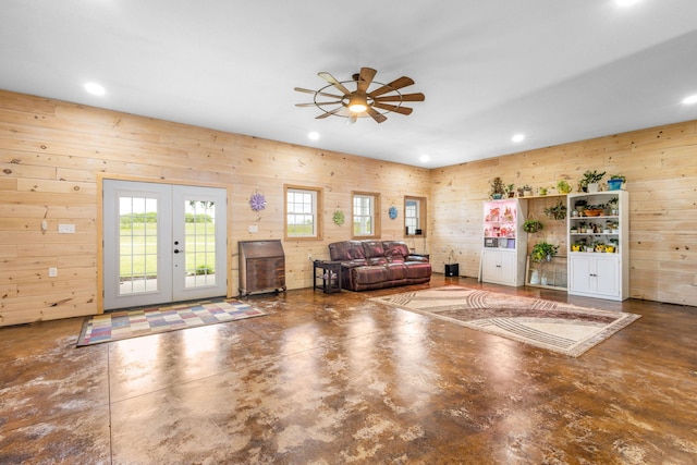 17495 Bison Trl, White Pigeon, MI 49099 - living room with a ceiling fan, wooden walls, french doors, finished concrete floors, and recessed lighting