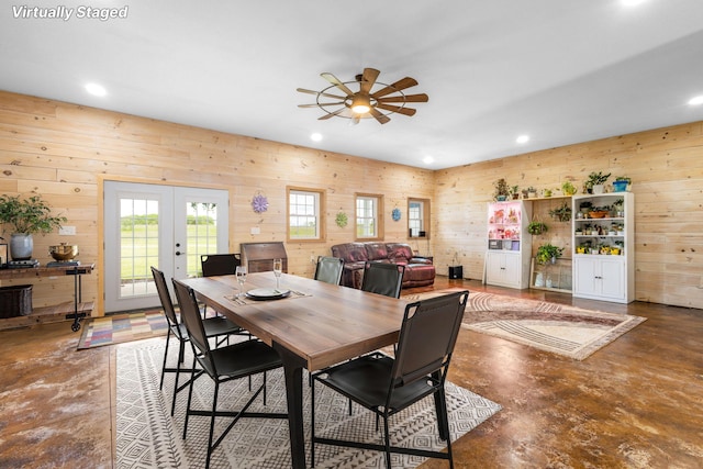 17495 Bison Trl, White Pigeon, MI 49099 - dining area featuring finished concrete flooring, a ceiling fan, french doors, wooden walls, and recessed lighting