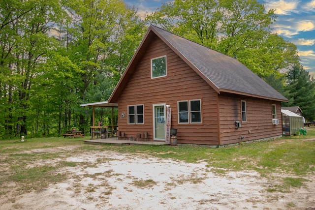 6210 W Monroe Rd, Hesperia, MI 49421 - rustic home with a shingled roof and a wooden deck