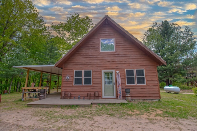 6210 W Monroe Rd, Hesperia, MI 49421 - back of property at dusk featuring a wooden deck