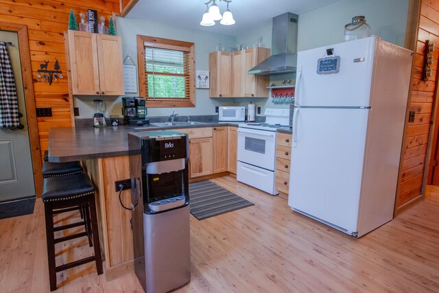 6210 W Monroe Rd, Hesperia, MI 49421 - kitchen with white appliances, wall chimney range hood, light brown cabinets, light wood finished floors, and dark countertops