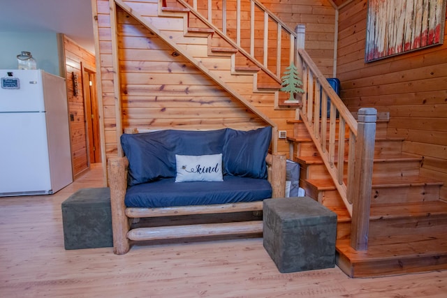 6210 W Monroe Rd, Hesperia, MI 49421 - sitting room featuring wooden walls, stairway, and wood finished floors