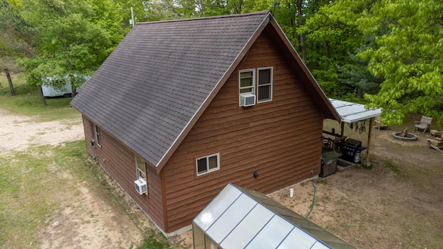 6210 W Monroe Rd, Hesperia, MI 49421 - view of side of home featuring an outdoor fire pit and cooling unit