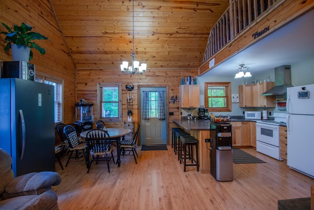 6210 W Monroe Rd, Hesperia, MI 49421 - kitchen with white appliances, wall chimney range hood, a chandelier, dark countertops, and high vaulted ceiling