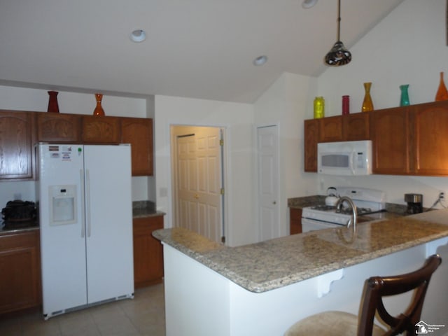 36111 Traditions Dr, Westland, MI 48185 - kitchen featuring white appliances, a peninsula, lofted ceiling, light tile patterned floors, and a breakfast bar area