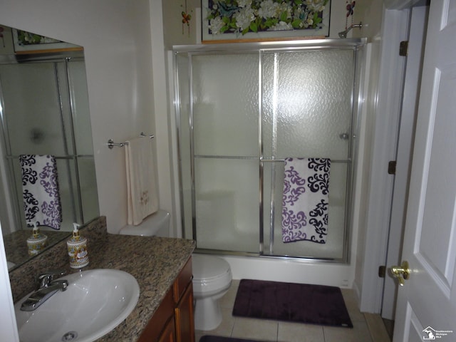 36111 Traditions Dr, Westland, MI 48185 - full bathroom with a shower with door, vanity, tile patterned floors, and toilet