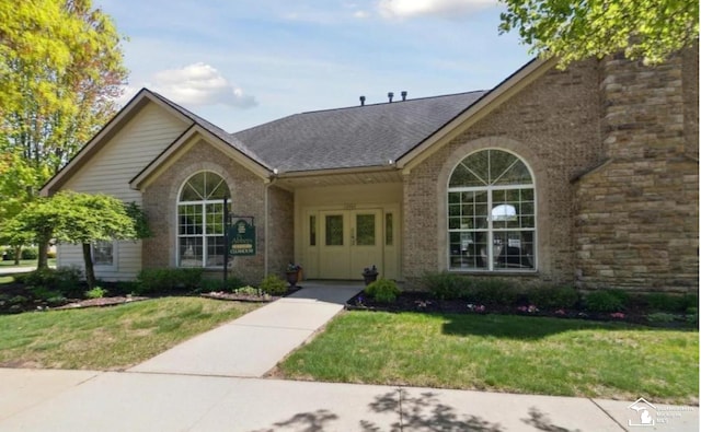 36111 Traditions Dr, Westland, MI 48185 - view of front of home featuring a front yard, brick siding, and a shingled roof