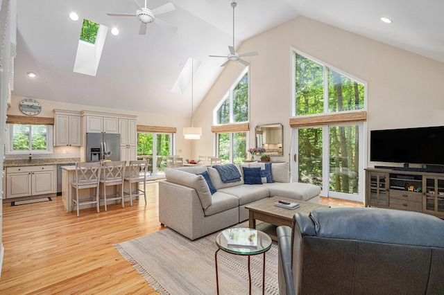 12215 Dunes Rd, Sawyer, MI 49125 - living room with a skylight, high vaulted ceiling, ceiling fan, light wood finished floors, and recessed lighting