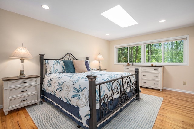 12215 Dunes Rd, Sawyer, MI 49125 - bedroom with a skylight, light wood-style floors, baseboards, and recessed lighting