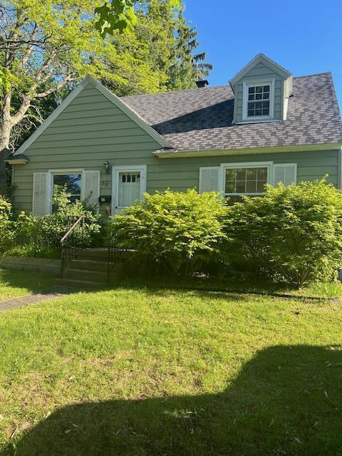 337 E Pine St, Fremont, MI 49412 - view of front of home featuring a front yard and roof with shingles