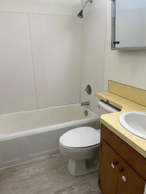337 E Pine St, Fremont, MI 49412 - bathroom featuring vanity, shower / washtub combination, toilet, and wood finished floors