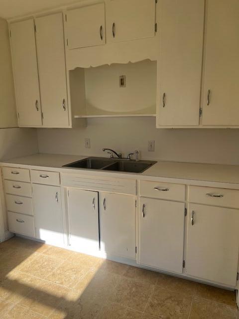337 E Pine St, Fremont, MI 49412 - kitchen featuring a sink, white cabinets, and light countertops