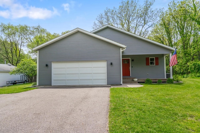 124 S Shore Dr, Portage, MI 49002 - view of front facade featuring asphalt driveway, a garage, and a front lawn