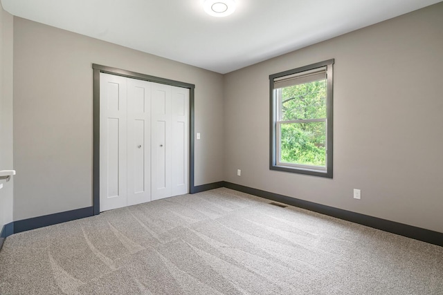 124 S Shore Dr, Portage, MI 49002 - unfurnished bedroom with carpet floors, baseboards, and a closet