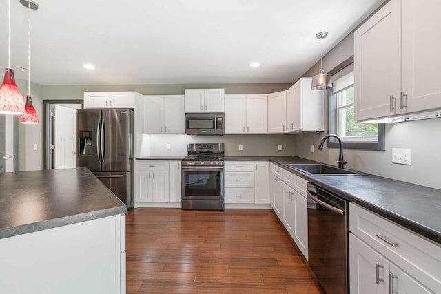 124 S Shore Dr, Portage, MI 49002 - kitchen featuring stainless steel appliances, dark countertops, a sink, white cabinetry, and recessed lighting