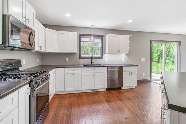 124 S Shore Dr, Portage, MI 49002 - kitchen with stainless steel appliances, a sink, dark countertops, healthy amount of natural light, and recessed lighting