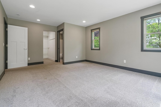 124 S Shore Dr, Portage, MI 49002 - unfurnished bedroom featuring carpet flooring, baseboards, recessed lighting, a spacious closet, and a closet