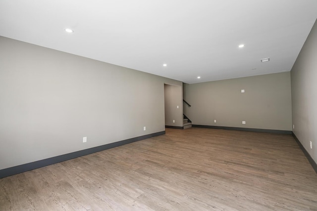 124 S Shore Dr, Portage, MI 49002 - unfurnished room featuring baseboards, light wood finished floors, stairs, and recessed lighting