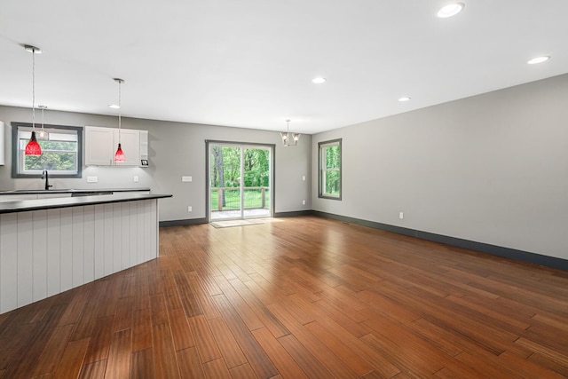124 S Shore Dr, Portage, MI 49002 - unfurnished living room featuring recessed lighting, dark wood-type flooring, plenty of natural light, a sink, and baseboards