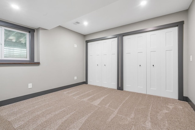 124 S Shore Dr, Portage, MI 49002 - unfurnished bedroom featuring two closets, carpet flooring, baseboards, and recessed lighting