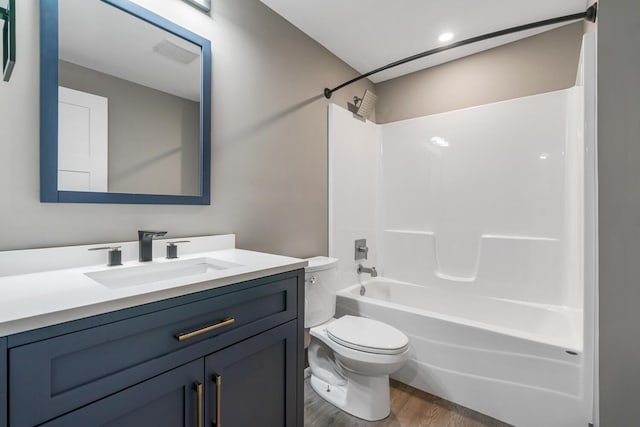 124 S Shore Dr, Portage, MI 49002 - full bathroom featuring toilet, wood finished floors, vanity, and washtub / shower combination