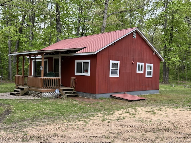 8953 18th Ave, Bitely, MI 49309 - view of front facade featuring metal roof and a wooden deck