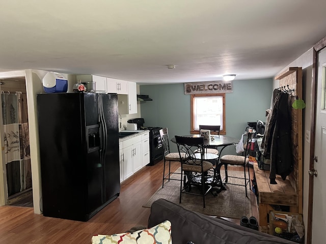 8953 18th Ave, Bitely, MI 49309 - kitchen featuring black appliances, white cabinets, dark wood-style flooring, and under cabinet range hood
