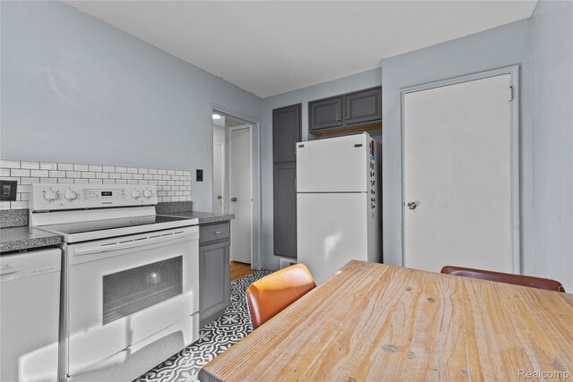 125 Tecumseh St, Clawson, MI 48017 - kitchen featuring white appliances, backsplash, gray cabinetry, and light wood finished floors