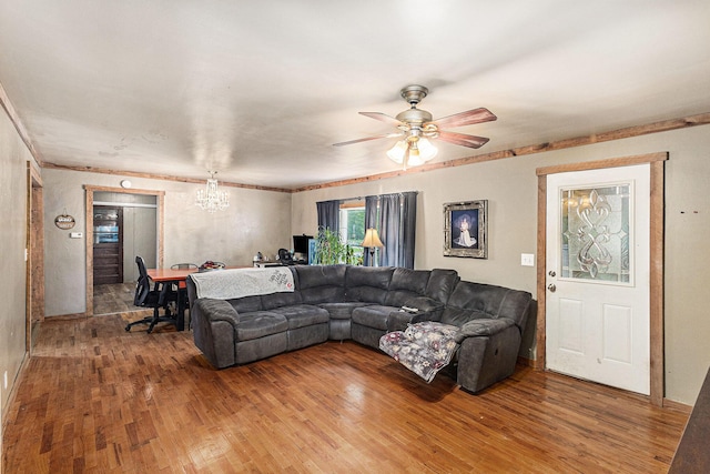 7694 Norconk Rd, Bear Lake, MI 49614 - living room featuring a chandelier, light wood-style flooring, ceiling fan, crown molding, and baseboards